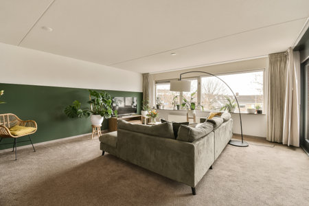 a living room with couches, chairs and a coffee table in front of a large window looking out onto the streetの写真素材