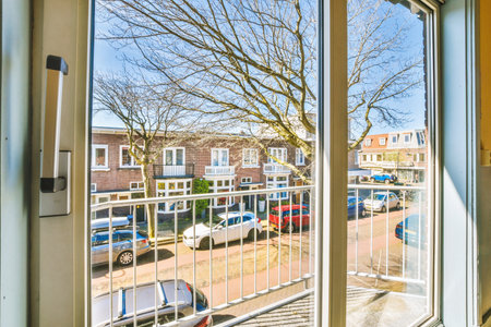 an outside area with cars parked in the lot and trees on the other side of the street as seen...