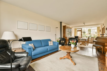 a living room with blue couches and white rugs on the floor in front of the sofa is a coffee table