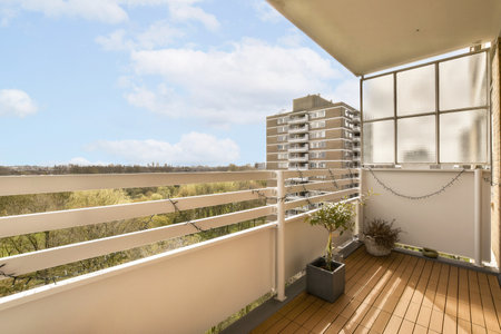 a balcony with some buildings in the background and trees on the other side of the building, as seen from the outsideの写真素材