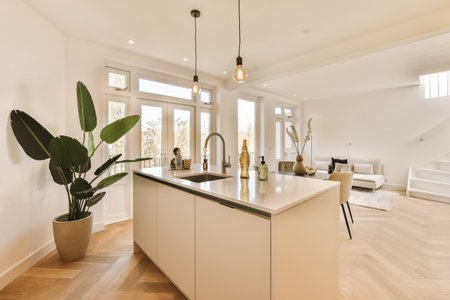 a kitchen and living room in a house with wood floors, white walls, hardwood flooring and large...