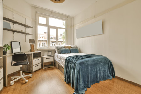 a bedroom with a bed, desk and computer on the floor in front of the window looking out onto the...
