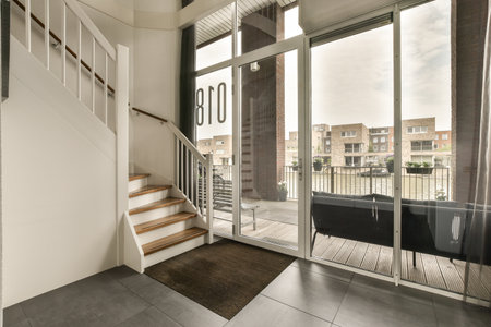 a living room with a balcony and staircase leading up to the second floor, which has been used for...