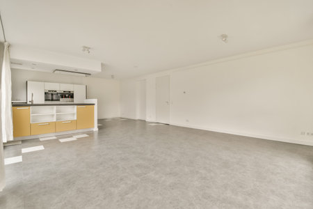 an empty living room with white walls and grey flooring in the room is very clean, but there is no...