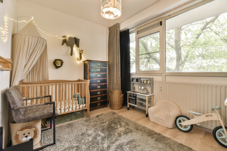 a babys room with a cribt in the corner and toys on the floor next to the cribt