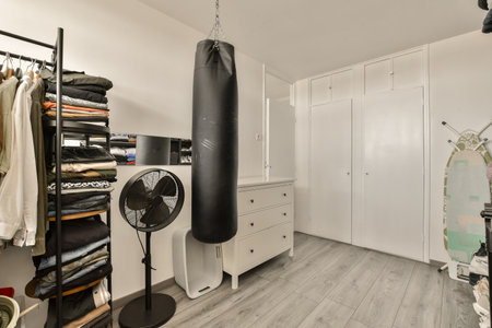 the inside of a room with a punching bag hanging on the wall and several other items in the closet...