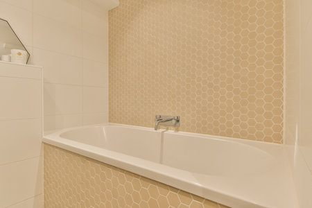 a bathroom with hexagon tiles on the wall and bathtub in the corner, next to a showerの写真素材