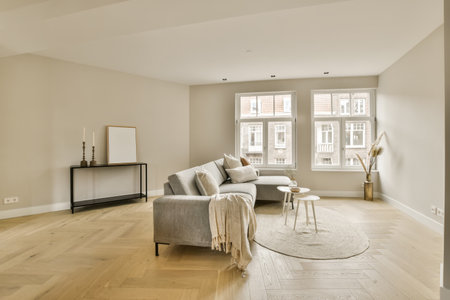 a living room with hardwood flooring and white walls in the center of the room is a large window that looks out onto theの写真素材