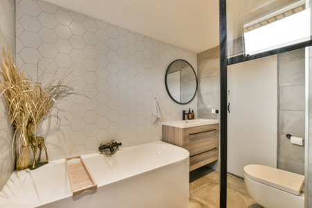a modern bathroom with hexagon tiles on the wall and wood cabinets in the corner, along with a...