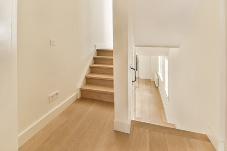 the inside of a house with wood flooring and stairs leading up to the second floor in an empty room