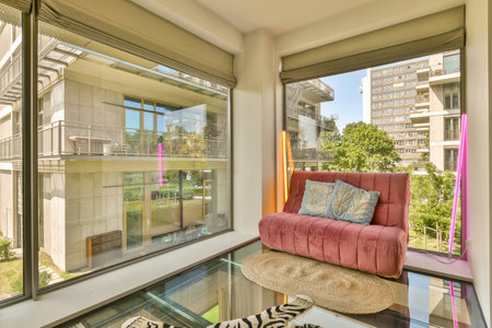 a living room with a pink couch and zebra rugs on the floor in front of the window looking out