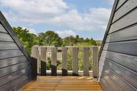 an outdoor area with wood floors and wooden sls on the side of a building that is surrounded by...