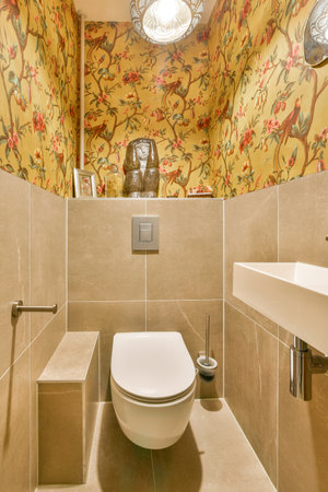 A stylish and modern bathroom featuring decorative wallpaper, elegant lighting, and sleek fixtures...