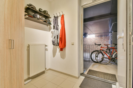 A contemporary entryway showcasing a bicycle, sports apparel, and a combination of functional decor...
