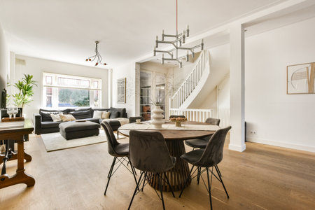 A stylish modern living room featuring a comfortable sofa, elegant dining setup, and ample natural...