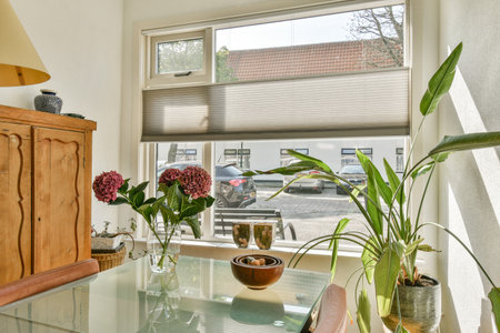 A beautifully arranged indoor setting featuring a wooden cabinet, plants, and decorative items,...
