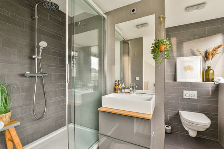 A sleek, contemporary bathroom featuring a shower, sink, and tasteful decor. The integration of...