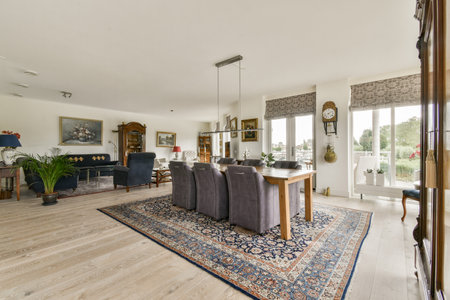 Spacious living room featuring contemporary furnishings, a stylish rug, and abundant natural light,...