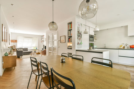 A stylish, modern dining area featuring a large wooden table, sleek chairs, and bright decor,...