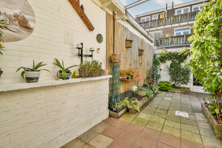 A well-designed outdoor garden area featuring greenery, decorative plants, and stylish architecture,...