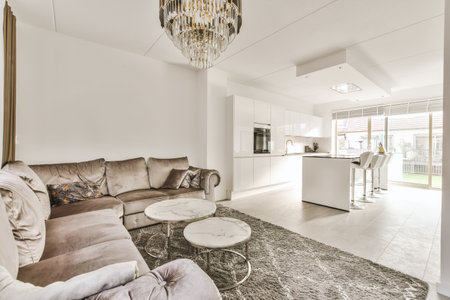 a living room with couches, coffee table, and chandels on the wall