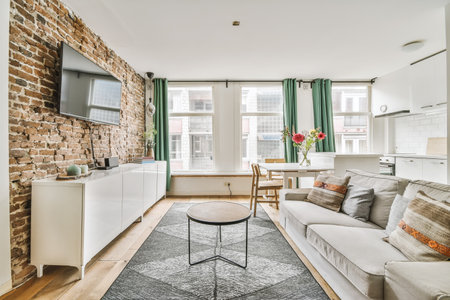 a living room with exposed brick walls and an area rug that has been used as a carpet for the floorの写真素材