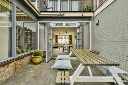 A stylish outdoor patio featuring a blend of modern design and rustic elements, showcasing...