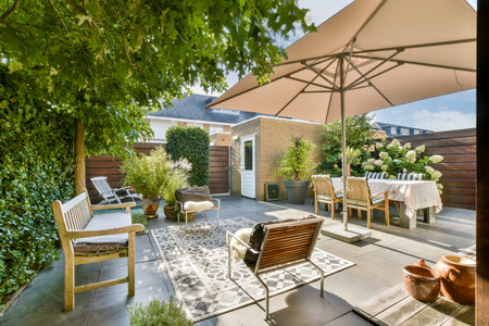 A beautifully designed outdoor patio featuring lush greenery, comfortable seating, and an inviting...