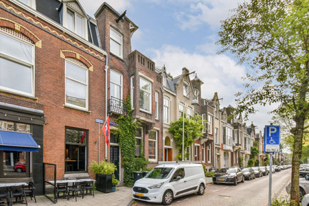 A picturesque street lined with historic buildings adorned with greenery. This scene captures the essence of architectural beauty and urban life.の写真素材