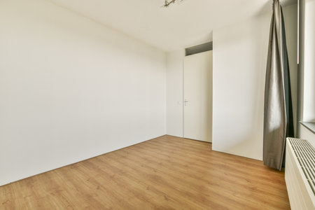 A modern, minimalist interior featuring empty walls and flooring, emphasizing simplicity in design...