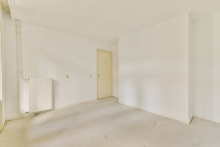 A minimalistic and clean white interior showcasing an empty room with plain walls and flooring, emphasizing simplicity and spaciousness.の写真素材
