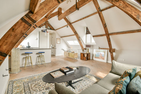 A stylish interior space showcasing beautiful exposed wooden beams, contemporary furniture, and a...