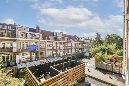 A picturesque view of an urban residential area featuring balconies, plants, and clear blue skies, perfect for showcasing modern living spaces.の写真素材