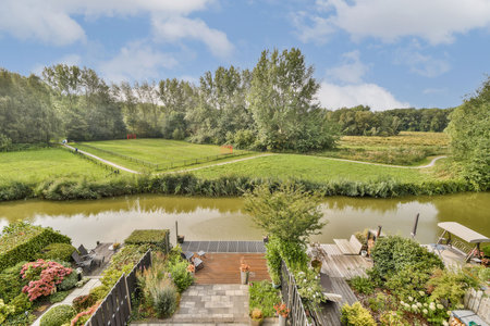 A tranquil scene featuring a winding river surrounded by vibrant greenery, showcasing a peaceful outdoor environment ideal for relaxation and nature appreciation.の写真素材