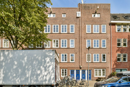 A modern urban building display features large windows and a brick facade with bicycles parked in front, embodying contemporary city life.の写真素材