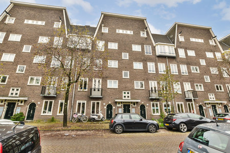 An array of modern residential buildings featuring distinct architectural designs, balconies, and a vibrant neighborhood atmosphere.の写真素材