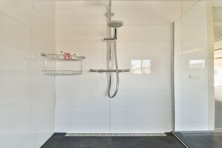 A contemporary shower area featuring clean tile lines and minimalistic fixtures, perfect for a stylish bathroom upgrade.の写真素材