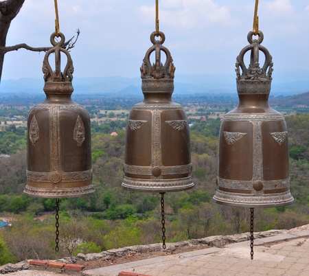 three metallic bells hangingの写真素材