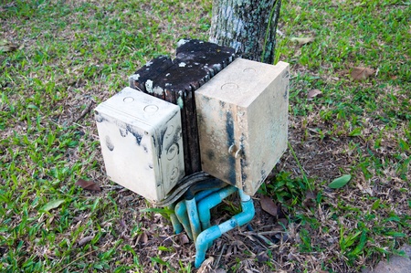 Plastic pipes containing electrical cables in old boxの写真素材