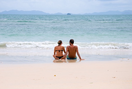 Young happy couple sitting on beach  Railay, Krabi province Thailand  の写真素材