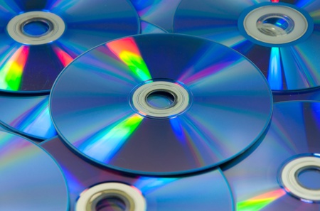 colorful compact discs, set of DVD scattered on a table.の写真素材