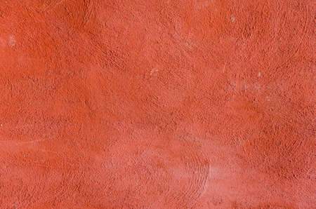 Cement background with a texture of a red wall.
