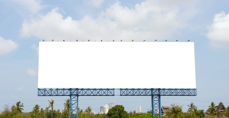large blank billboard on road with city view background.の写真素材