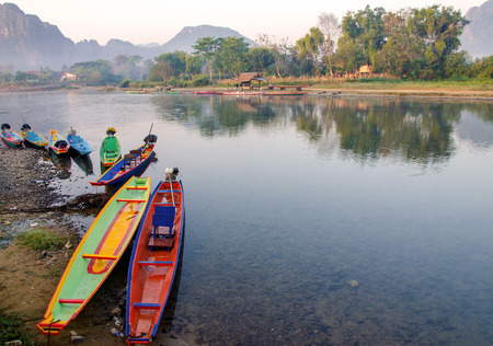 long tail boats on Song river, Vang Vieng, Laos.