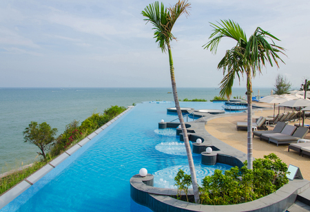 Swimming pools and bar at the beach of luxury hotel.のeditorial素材