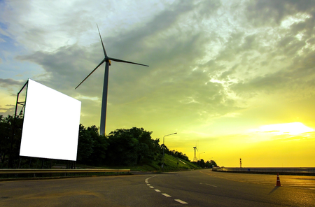 blank billboard on wind turbine generating electricity.の写真素材
