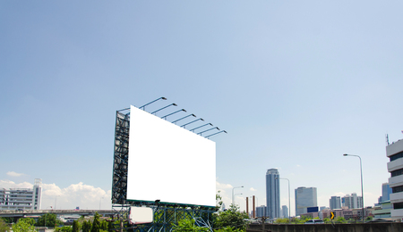 large blank billboard on road with city view backgroundの写真素材