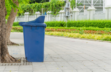 trash cans in the park beside the walk way.の写真素材