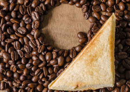 toast bread on coffee beans background.の写真素材