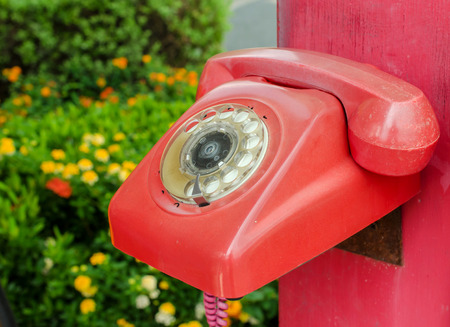 Old red phone vintage style on park.の写真素材